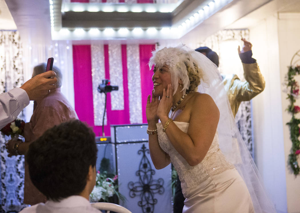 Lauren Santiago responds to a Facebook Live stream saying "it's for real" during their wedding at the Little Vegas Chapel in Las Vegas on Saturday, April 1, 2017. (Chase Stevens/ ...