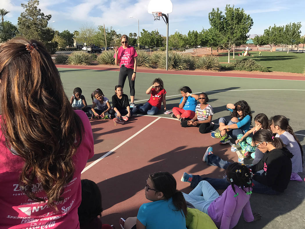 The girls participating in Girls on the Run sit in a circle at the end of their practice 5K run March 28 at Paseo Vista Park. (Danny Webster/View)