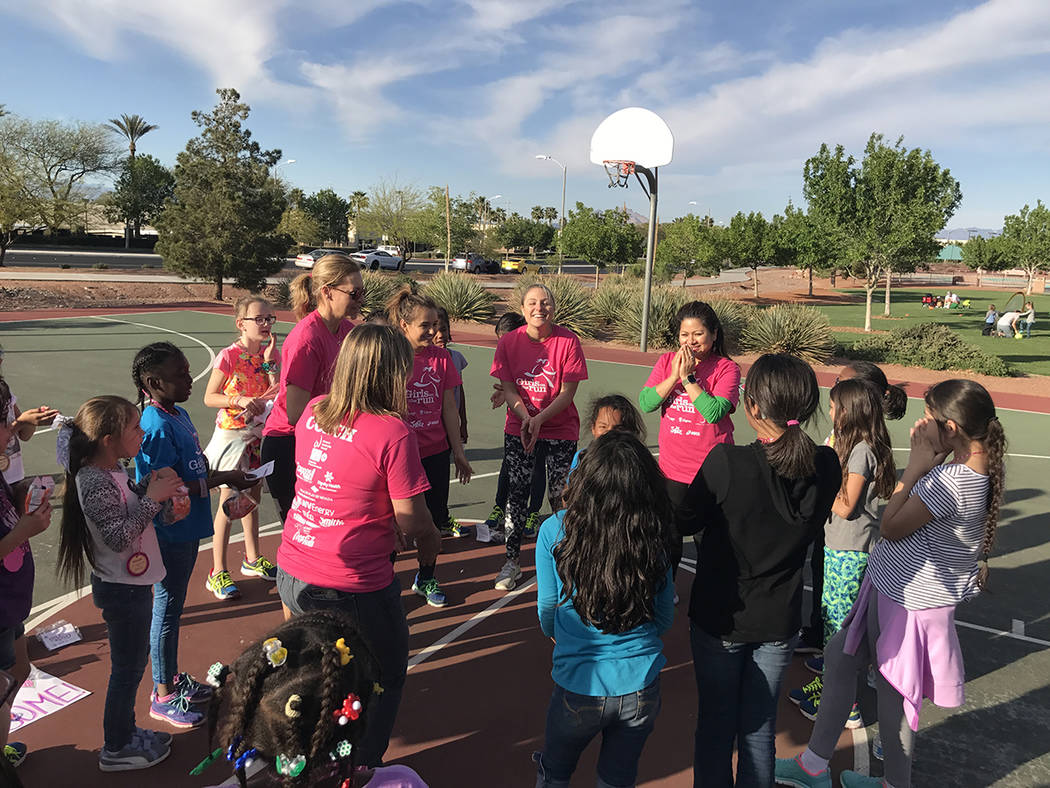 Led by coach Abby Guida, the girls and coaches participate in their "Energy Awards" portion after their practice 5K March 28 at Paseo Vista Park. (Danny Webster/View)
