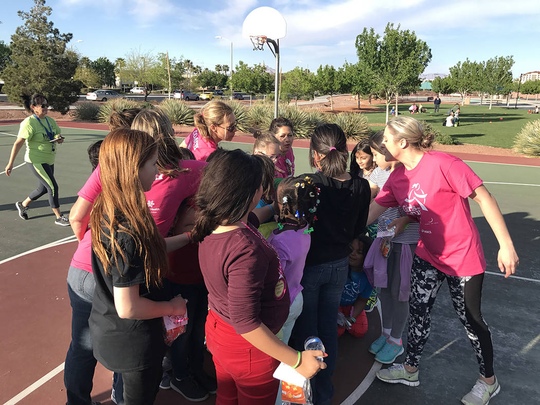 The Dignity Health Girls on the Run team huddle up after running their practice 5K run March 28 at Paseo Vista Park. (Danny Webster/View)