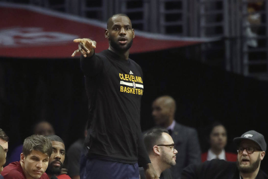 Cleveland Cavaliers' LeBron James watches from the bench during the first half of an NBA basketball game against the Los Angeles Clippers, Saturday, March 18, 2017, in Los Angeles. (AP Photo/Jae C ...