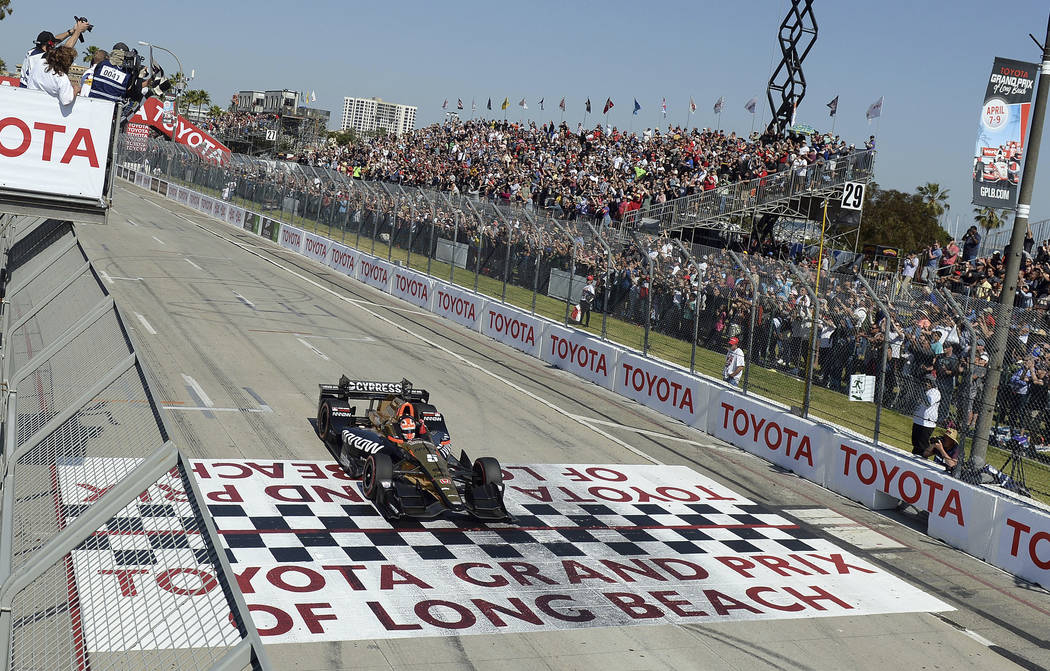Indycar driver James Hinchcliffe takes the checkered flag to win the 43rd Toyota Grand Prix of Long Beach Sunday April 2017. (Will Lester/Los Angeles Daily News via AP)