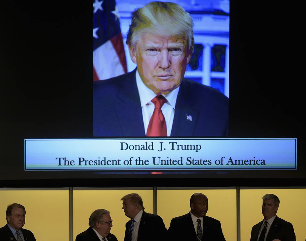 President Donald Trump, center, greets people as he arrives to speak at the 2017 North America's Building Trades Unions National Legislative Conference in Washington, Tuesday, April 4, 2017. (AP P ...