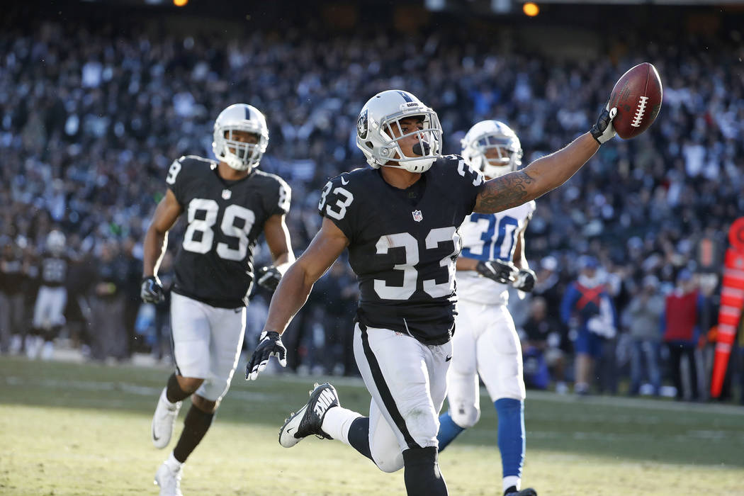 Oakland Raiders running back DeAndre Washington (33) celebrates after running for a touchdown against the Indianapolis Colts during the second half of an NFL football game in Oakland, California, ...