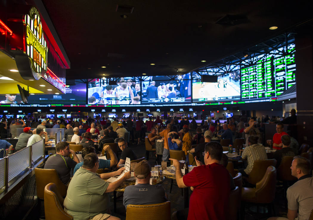 People sit outside the Superbook Deli during the first day of the NCAA basketball tournament at the Westgate sports book in Las Vegas on March 16, 2017. (Chase Stevens/Las Vegas Review-Journal) @c ...
