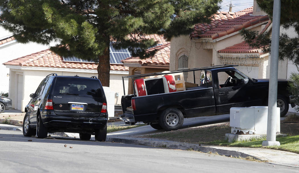 Cars in front of an alleged, active squatter home on Wednesday, April 5, 2017, in North Las Vegas. Unlawful occupants of abandoned homes can easily turn on the power, water, gas and cable. Christi ...