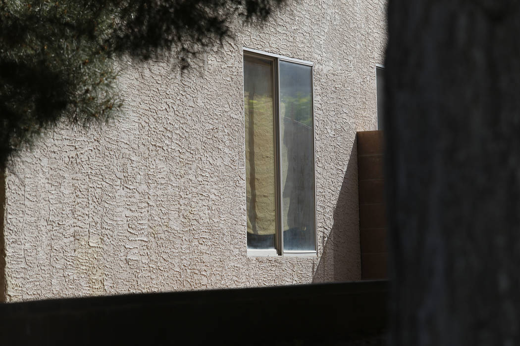 Covered windows inside of an alleged squatter home on Wednesday, April 5, 2017, in North Las Vegas. Unlawful occupants of abandoned homes can easily turn on the power, water, gas and cable. Christ ...