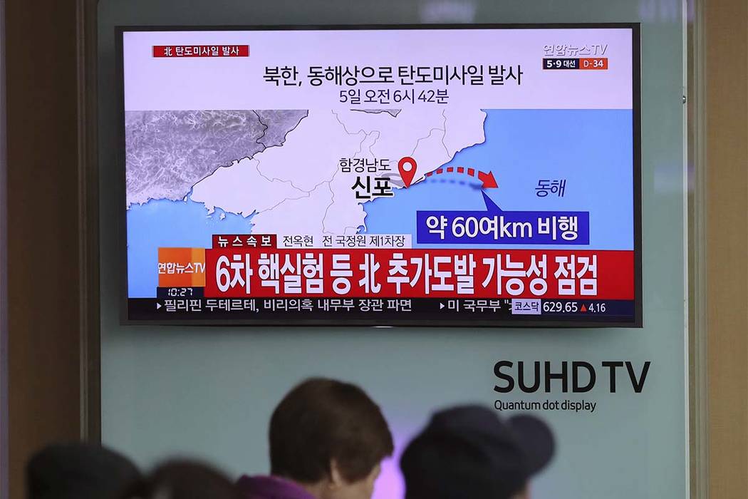 Visitors sit in front of the TV screen showing a news program reporting about North Korea's missile firing, at Seoul Train Station in Seoul, South Korea, Wednesday, April 5, 2017. (Lee Jin-man/AP)