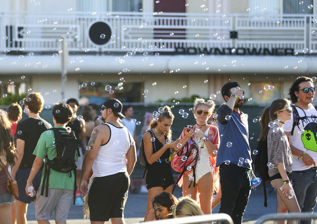 Attendees Watch As Bubble Pass By During The Life Is Beautiful Music And Arts Festival In