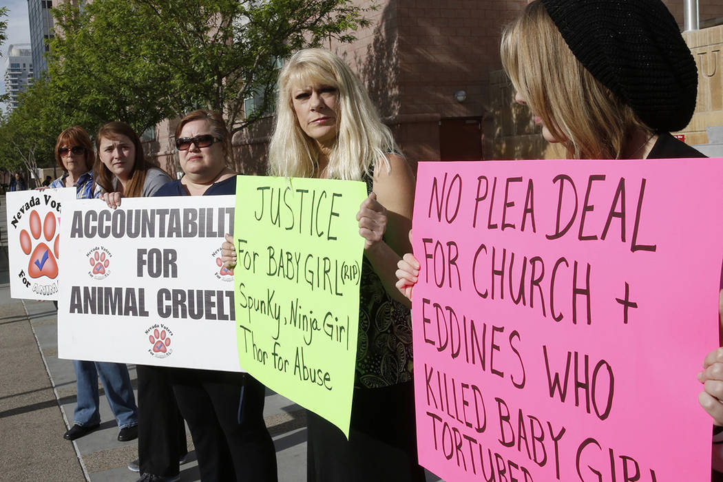 Nia Wulkan, second right, owner of a cat that was killed by neighbors, protests with animal rights activists, including Gina Greisen, center, president of Nevada Voters for Animals outside the Reg ...