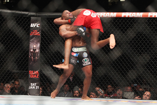 Jon Jones is lifted by Daniel Cormier during their fight at UFC 182 Saturday, Jan. 3, 2015 at the MGM Grand Garden Arena. Jones won a unanimous decision. (Sam Morris/Las Vegas Review-Journal)