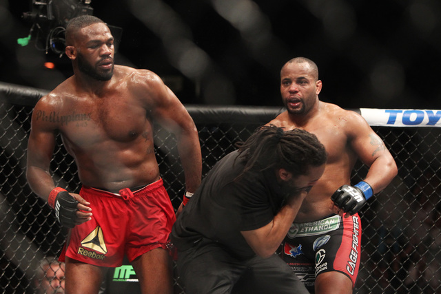 Referee Herb Dean reacts after getting caught up in a final flurry between Jon Jones and Daniel Cormier after the fifth round of their fight at UFC 182 Saturday, Jan. 3, 2015 at the MGM Grand Gard ...