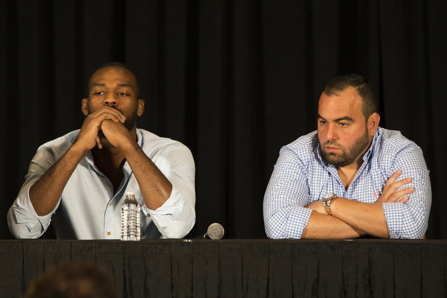 An emotional Jon Jones, left, addresses questions about the cancellation of his light heavyweight fight with Daniel Cormier at UFC 200 during a press conference at the MGM Grand Garden Arena on Th ...
