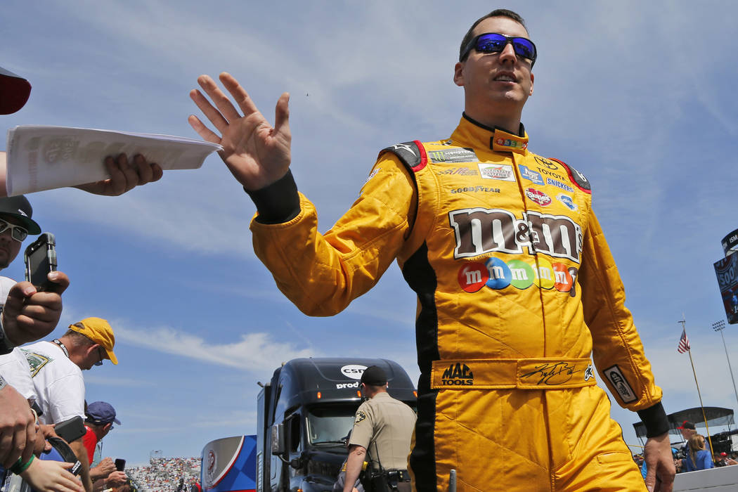 Kyle Busch greets fans during driver introductions prior to the start of the NASCAR Cup Series auto race at Martinsville Speedway in Martinsville, Va., Sunday, April 2, 2017. (Steve Helber/AP)