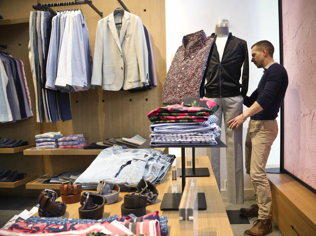 Bonobos manager Stephen Lusardi arranges clothing at the brand's Guideshop in New York's Financial Districtt, March 20, 2017. (Bebeto Matthews/AP)