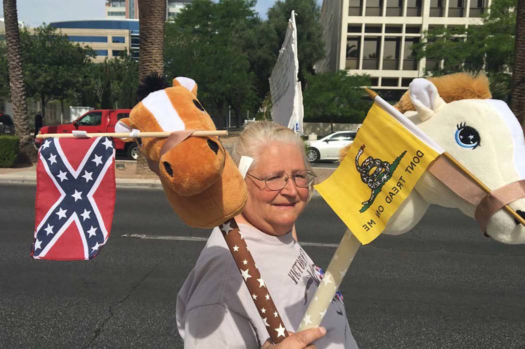 A woman protests outside the Lloyd George U.S. Courthouse as a jury has reached a verdict in the first trial of men charged in the 2014 armed standoff in Bunkerville, Monday, April 24, 2017. Bizua ...
