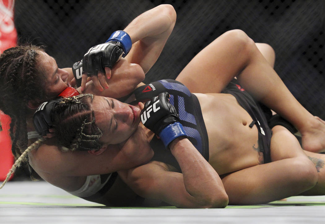 Cynthia Calvillo uses a submission hold on Pearl Gonzalez during a strawwei...