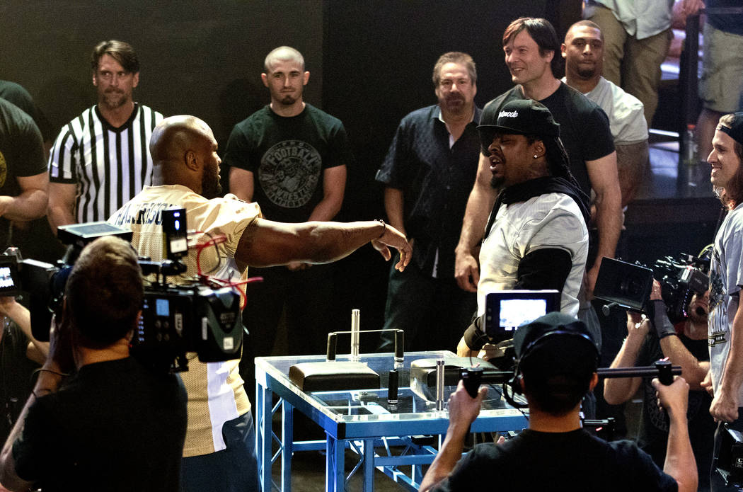 Team coaches and former NFL players James Harrison, gold jersey, and Marshawn Lynch, silver jersey, smack talk at the inaugural Pro Football Armwrestling Championship, which was filmed at the MGM  ...