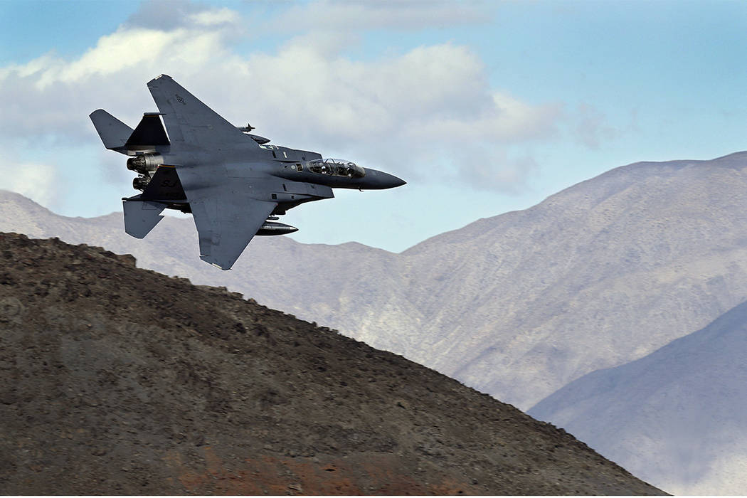 In this Feb. 27, 2017, photo , an F-15E 22 Eagle from Seymour Johnson AFB in North Carolina flies out of the nicknamed Star Wars Canyon turning toward the Panamint range over Death Valley National ...