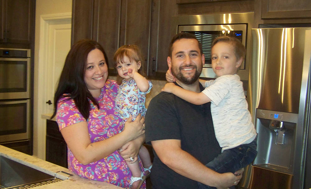 Andrew and Gina Lanzino, along with their children, Joey and Bella, relax in the model-home-inspired kitchen of their brand new home by Century Communities at Alpine Crossings in Skye Canyon. (Cou ...