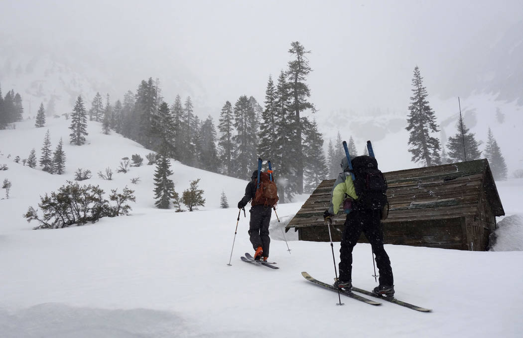 In this photo taken March 30, 2017, Kevin Klinefelter, left, and John Dittli, right, begin to ski toward Kearsarge Pass in Inyo National Forest near Independence, Calif., where they hoped to condu ...