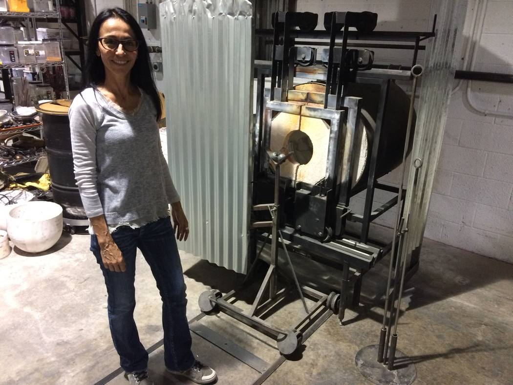 Barbara Domsky poses by one of the hot ovens April 7, 2017, at Domsky Glass, 2758 S. Highland Drive. She and her husband, Larry, usual make commissioned pieces but wanted locals to see how glass b ...