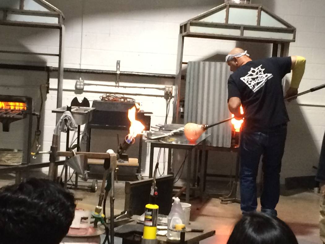 Larry Donsky take molted glass out of the glory hole April 7, 2017, during an exhibition at Domsky Glass, 2758 S. Highland Drive. He and his wife, Barbara, usual make commissioned pieces but wante ...