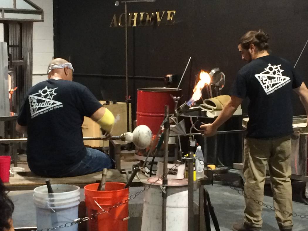 Larry Domsky, left, works the hot glass as assistant Matt Humphrey helps April 7, 2017, during an exhibition at Domsky Glass, 2758 S. Highland Drive. Owned by Larry and his wife, Barbara, the stud ...