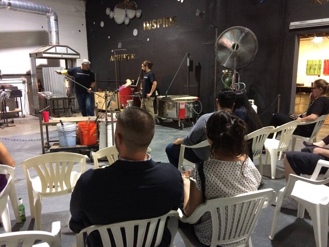 Attendees at a glass blowing demonstration were kept well back from the 2,200-degree ovens where glass was melted to create artistic pieces. Domsky Glass is opening up its studio one weekend a mon ...