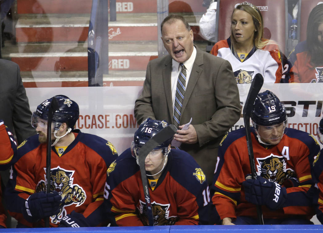 Florida Panthers head coach Gerard Gallant talks with his players in the third period of an NHL hockey game against the Edmonton Oilers, Saturday, Jan. 17, 2015, in Sunrise, Fla. (AP Photo/Lynne S ...