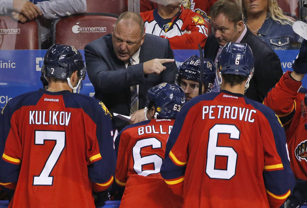 Florida Panthers head coach Gerard Gallant, rear, gestures as he talks to players during the third period of an NHL hockey game against the Buffalo Sabres, Thursday, Oct. 15, 2015 in Sunrise, Fla. ...