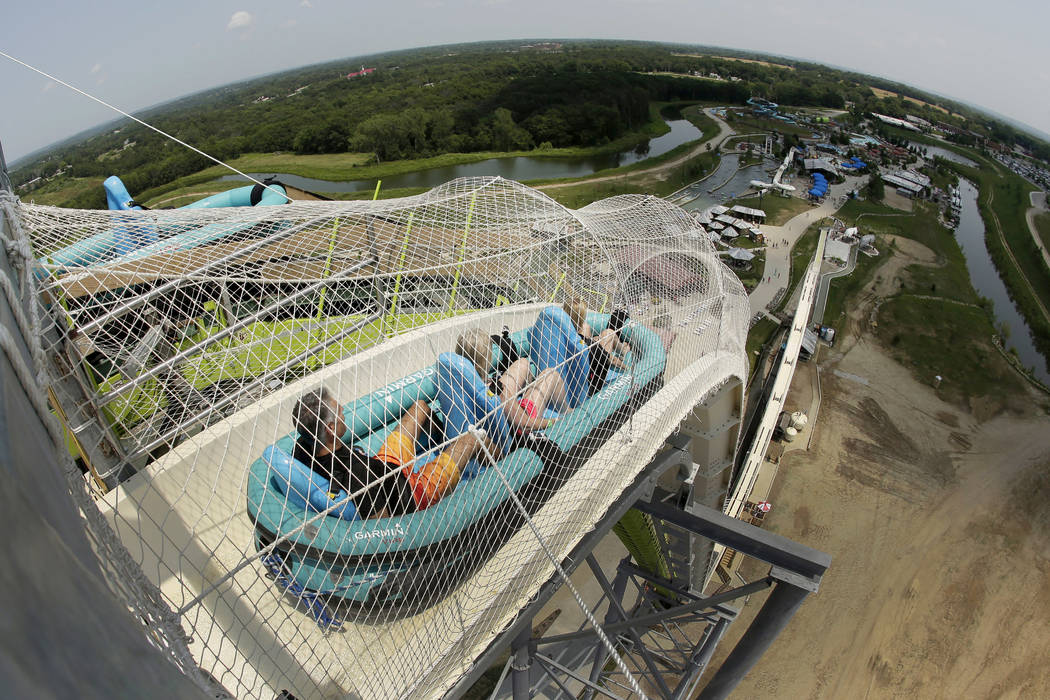 Riders go down the Verruckt waterslide at Schlitterbahn Waterpark in Kansas City, Kan. The family of Caleb Schwab, a Kansas lawmaker's son who was killed Aug. 7, 2016, on the ride, has reached a s ...