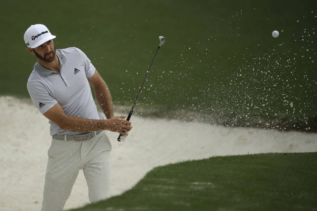 Dustin Johnson hits from a bunker on the 10th hole during a practice round for the Masters golf tournament Wednesday, April 5, 2017, in Augusta, Ga. (Charlie Riedel/AP)