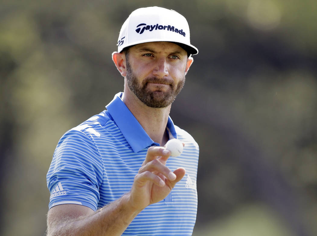 In this March 26, 2017, file photo, Dustin Johnson waves to the gallery after a birdie putt on the sixth hole during semifinal play at the Dell Technologies Match Play golf tournament at the Austi ...