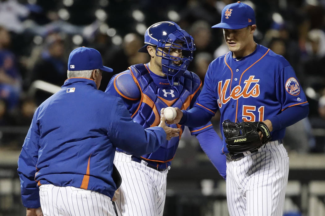 New York Mets manager Terry Collins, left takes pitcher Paul Sewald, right, out of the game as catcher Travis d'Arnaud watches during the eighth inning of a baseball game against the Miami Marlins ...