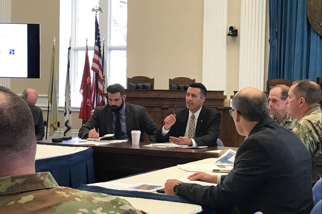Gov. Brian Sandoval, center, holds a briefing Thursday, April 13, 2017 in Carson City with emergency managers and public safety officials to discuss preparations for the spring snowmelt and Northe ...