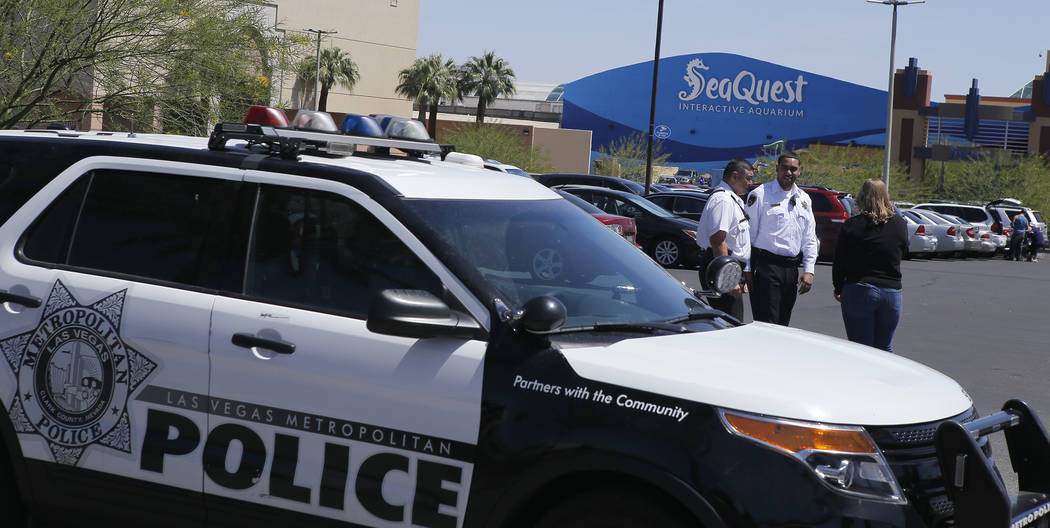 Las Vegas police and private security guards watch a protest near Seaquest Interactive Aquarium at Boulevard Mall on Saturday, April 15, 2017, in Las Vegas. Former and current employees from Seaqu ...