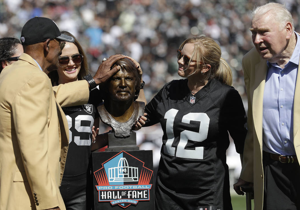 Former Oakland Raiders player Willie Brown, left, and former head coach John Madden, right, stand with family members of quarterback Ken Stabler next to Stabler's Pro Football Hall of Fame bust at ...