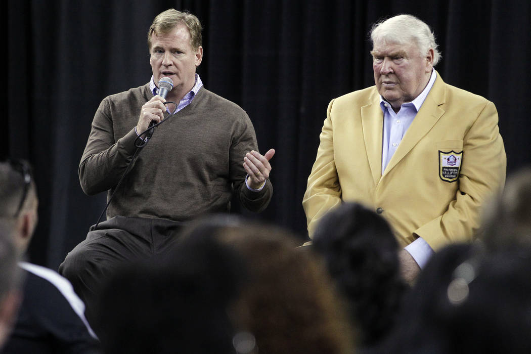 NFL Commissioner Roger Goodell, left, and Hall of Famer John Madden, right, participate in a fan forum before a football game between the Oakland Raiders and the Denver Broncos in Oakland, Calif., ...