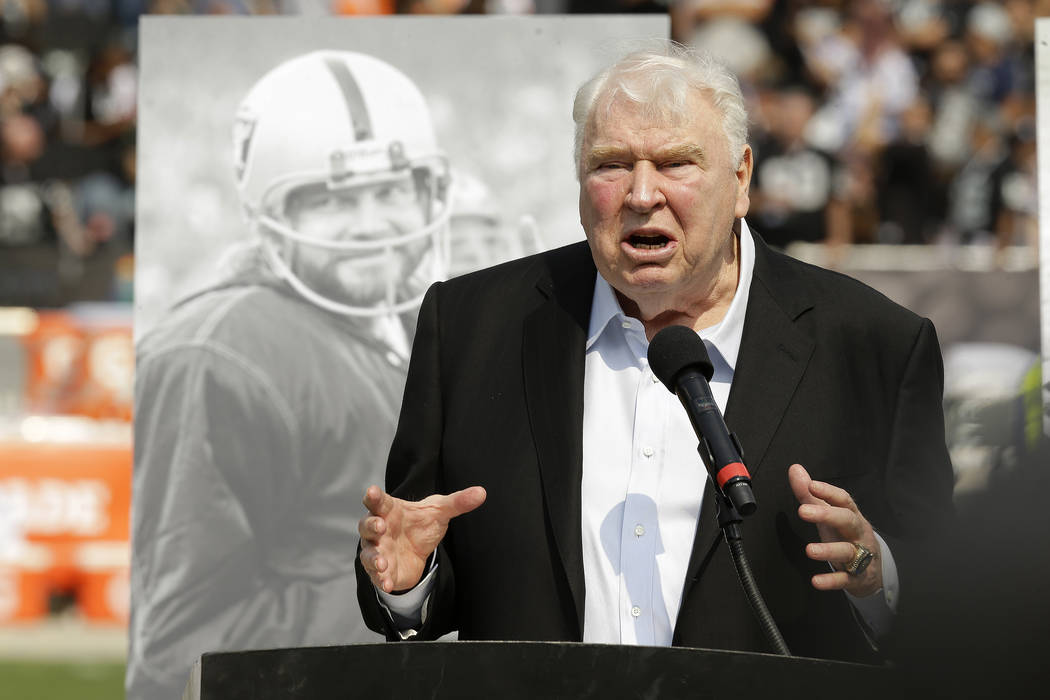 Former Oakland Raiders head coach John Madden speaks about former quarterback Ken Stabler, pictured at rear, at a ceremony honoring Stabler during halftime of an NFL football game between the Raid ...