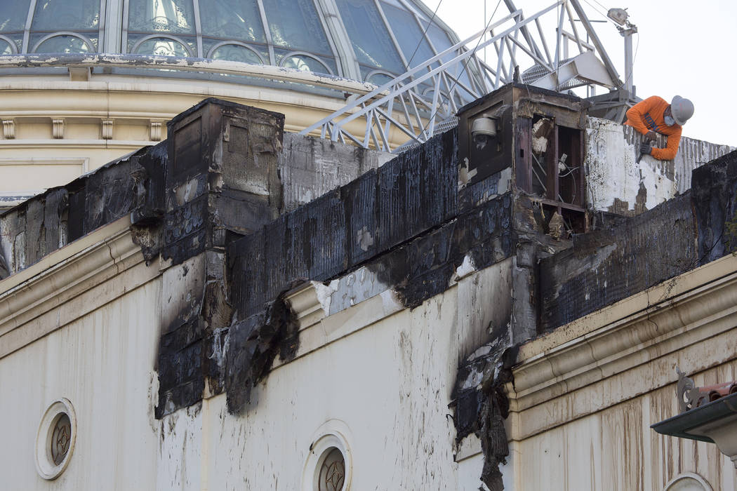 Damage from a roof fire the night prior is worked on at Bellagio hotel-casino on Friday, April 14, 2017 in Las Vegas. (Bridget Bennett/Las Vegas Review-Journal) @bridgetkbennett