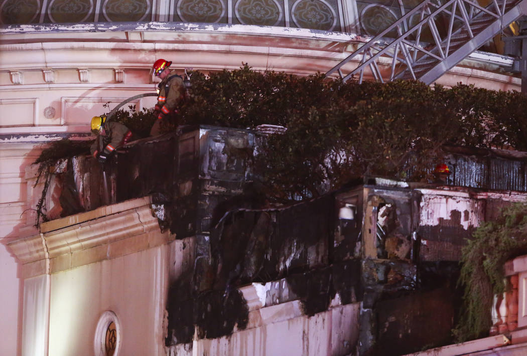 The Clark County Fire Department and other emergency personnel respond to the scene after part of the roof of the Bellagio hotel-casino caught fire in Las Vegas on Thursday, April 13, 2017. Chase  ...
