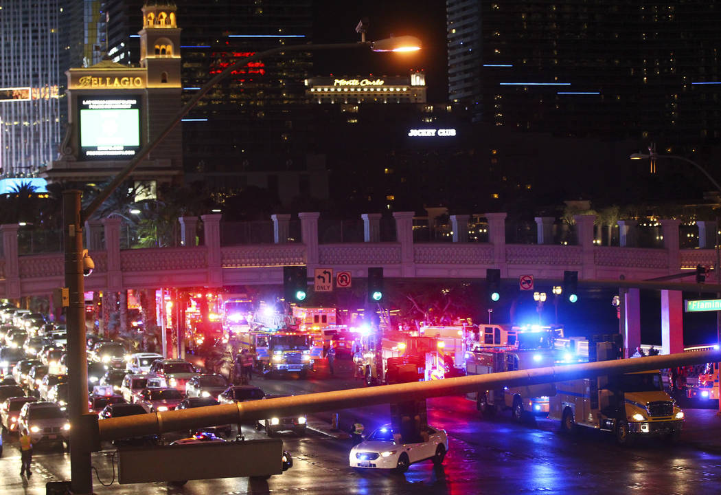 The Clark County Fire Department and other emergency personnel respond to the scene after part of the roof of the Bellagio hotel-casino caught fire in Las Vegas on Thursday, April 13, 2017. Chase  ...
