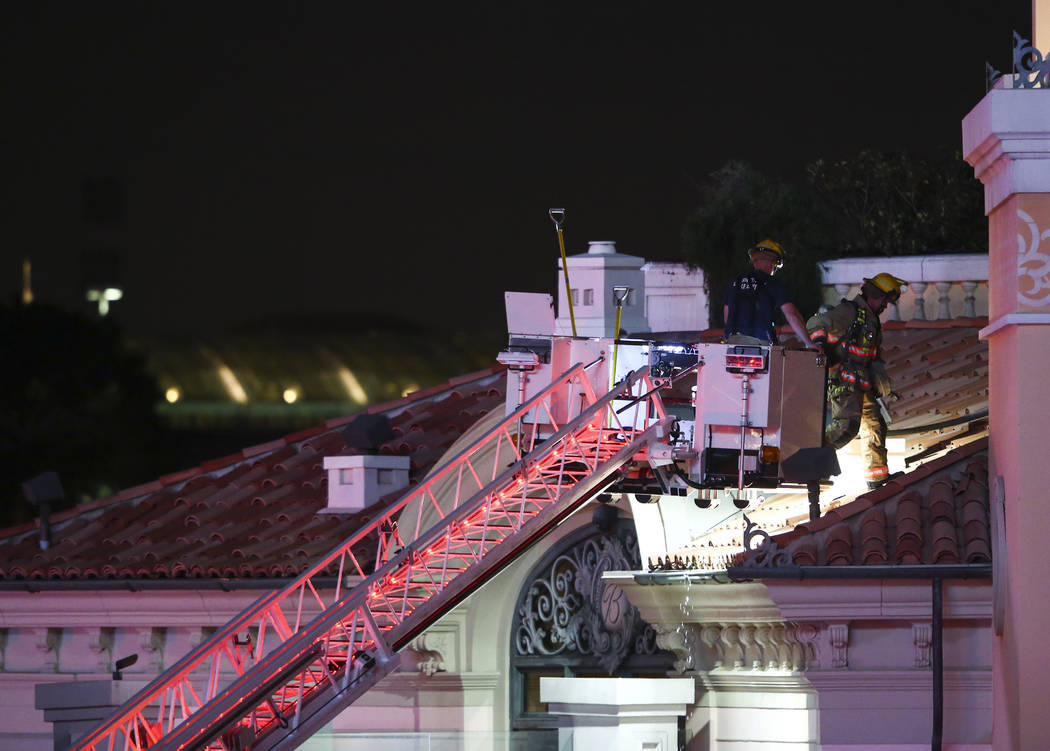 The Clark County Fire Department and other emergency personnel respond to the scene after part of the roof of the Bellagio hotel-casino caught fire in Las Vegas on Thursday, April 13, 2017. Chase  ...