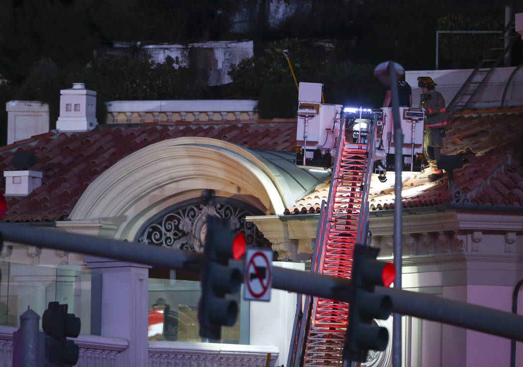 The Clark County Fire Department and other emergency personnel respond to the scene after part of the roof of the Bellagio hotel-casino caught fire in Las Vegas on Thursday, April 13, 2017. Chase  ...