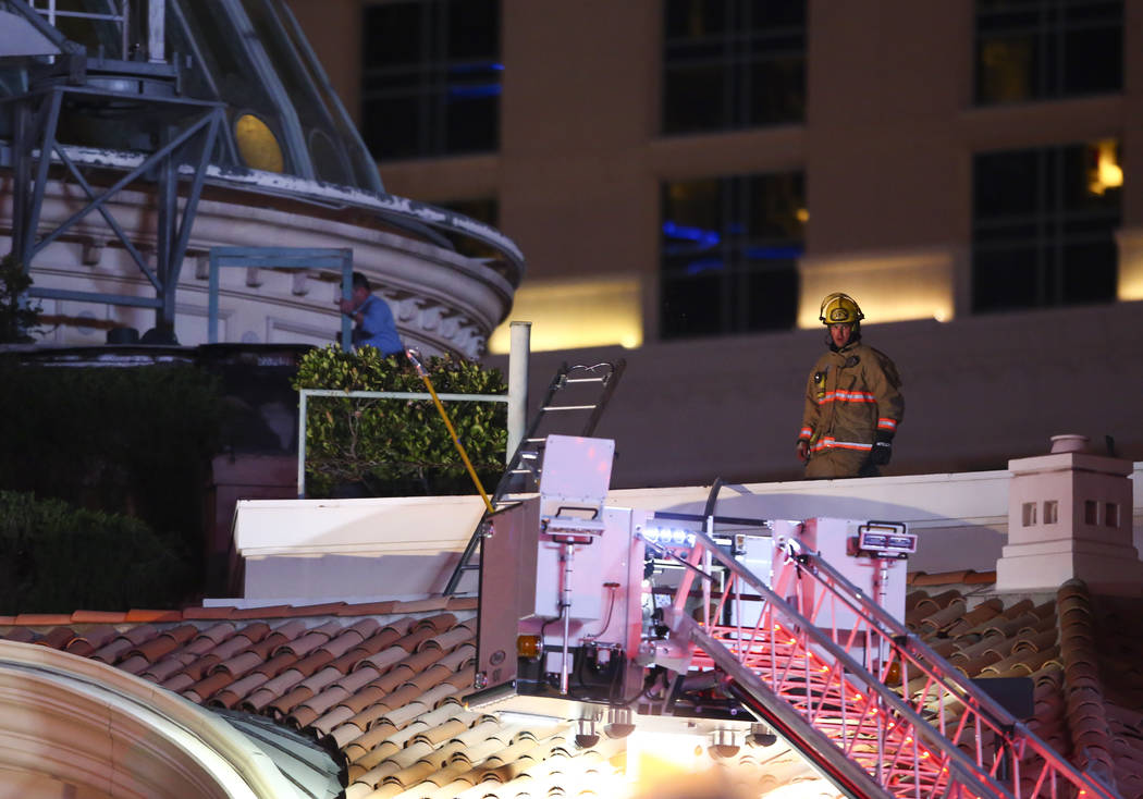 The Clark County Fire Department and other emergency personnel respond to the scene after part of the roof of the Bellagio hotel-casino caught fire in Las Vegas on Thursday, April 13, 2017. Chase  ...
