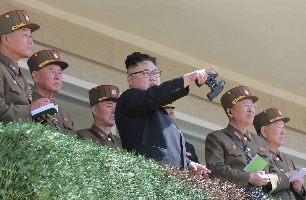 In this undated photo distributed on Friday, April 14, 2017, by the North Korean government, North Korean leader Kim Jong Un, center, watches a military drill at an undisclosed location.  Independ ...