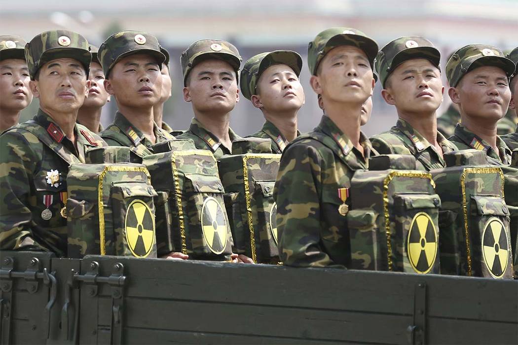 In this July 27, 2013, file photo, North Korean soldiers turn and look towards leader Kim Jong Un as they carry packs marked with the nuclear symbol at a parade in Pyongyang, North Korea. (Wong Ma ...