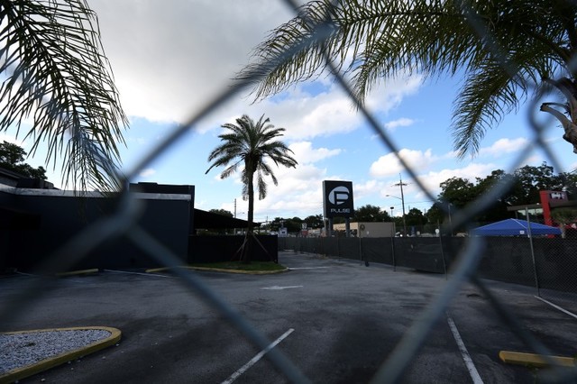 The Pulse night club sign is pictured through a fence following the mass shooting in Orlando, Florida. (Carlo Allegri/Reuters)