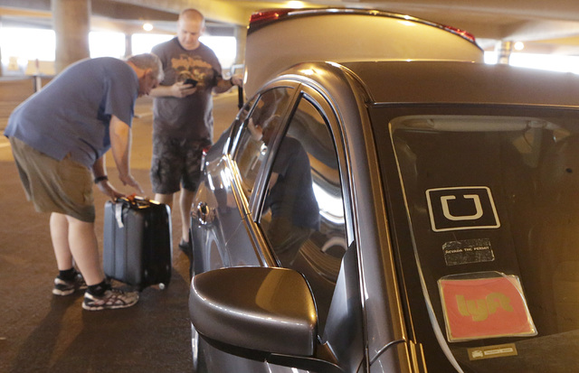 Riders prepare to load their luggage into an Uber and Lyft car at McCarran International Airport. (Bizuayehu Tesfaye/Las Vegas Review-Journal) @bizutesfaye